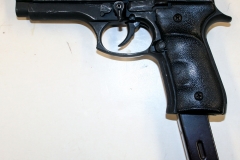 Non-firing replica Beretta 92 with extended magazine set-up.