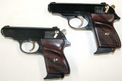 matched pair of replica black .380 automatic pistols, gold trim.