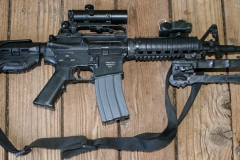 Non-firing replica M4 assault rifle with scope and bipod.